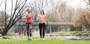 Long Distance Prints: Senior and young woman running as sport on a meadow in spring