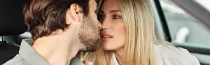 Intimacy Prints: sensual and stylish blonde woman seducing handsome bearded man while sitting in modern car