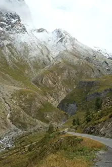 Winding Road Prints: Serene Drive Along Col de l'Iseran's Rugged Terrain