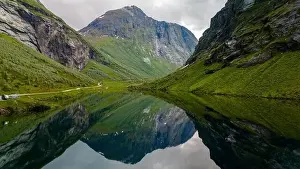 Mountainside Prints: A serene lake nestled amidst the towering mountains of Norway