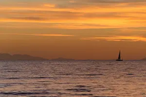 Golden Sky Prints: Serene Sunset Over Calm Ocean Horizon and Golden Sky, Tuscany, Italy
