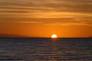 Golden Sky Prints: Serene Sunset Over Calm Ocean Horizon and Golden Sky, Tuscany, Italy