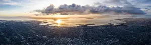 A serene sunset illuminates the densely populated San Francisco Bay area including Oakland, Berkeley, Emeryville, El Cerrito, and San Francisco