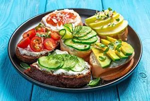 Feta Prints: A set of sandwiches with feta, ricotta, vegetables and fruits on a blue background