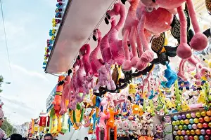From below set of various toy prizes hanging on stall during fair in amusement park