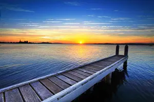 Unwind Prints: Setting sun behind the boat jetty, Lake Maquarie