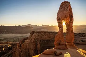 Sunburst Prints: Setting sun through Delicate Arch with sunburst