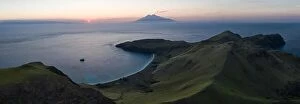 Aerial Landscape Collection: The setting sun silhouettes Sangeang Api, an active volcano located just outside Komodo National
