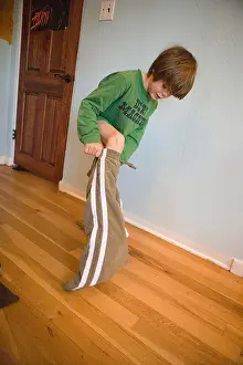 American United Prints: Seven year old boy getting dressed in the morning