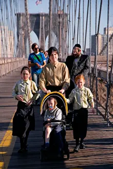 Daughters Prints: A severly dressed Orthodox Jewish woman pushes a stroller across the Brooklyn Bridge in Manhattan New York City Note