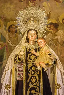 Faith Prints: Seville - The statue of traditional vested Madonna on the main altar of baroque church Iglesia de Buen Suceso