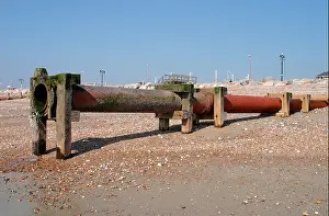Concern Prints: Sewage outlet pipe on beach at low tide in Worthing, West Sussex