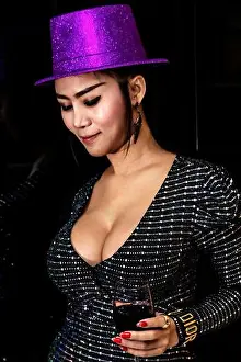Eyes Closed Prints: Sexy, beautiful asian lady with big breasts posing with glass of red wine and party hat