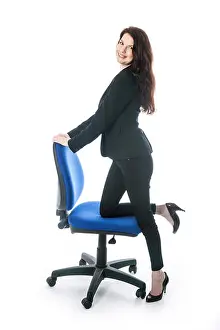 Woman Work Prints: sexy brunette with blue office chair in studio against white background