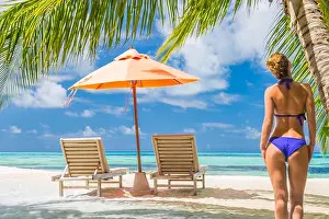 Meditate Prints: Sexy woman at peace in blue bikini on tropical beach under palm trees