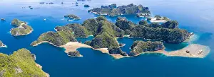 Shallow coral reefs surround remote limestone islands in Raja Ampat, Indonesia. This biodiverse region is known as the heart of the Coral Triangle