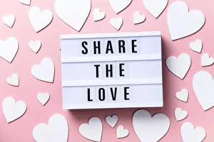 Flatlay Prints: Share the Love lightbox message with white hearts on a pink background