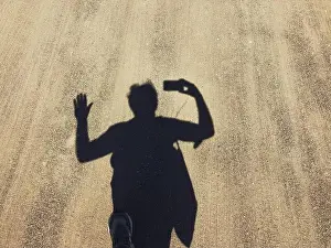 Hand Gesture Prints: Shdow of man walking on a path