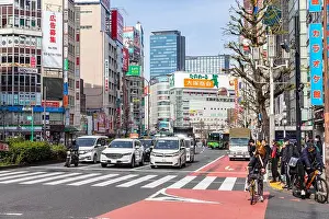 Spring Day Prints: Shinjuku Tokyo, April 2023 street urban scene traffic stops at zebra crossing with motorcyclist and cyclists
