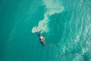Dredging Prints: Ship dredging in turqouoise water. Dubai, UAE
