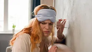Intimacy Prints: Shocked angry girl leaning to wall in bedroom at early morning curious Caucasian woman overhearing noisy neighbor using