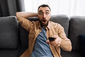 Shocked Prints: Shocked worried guy watch on tv sport channel