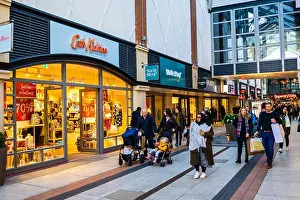Holiday Resort Prints: Shop fronts in the busy shopping mall in Gunwharf Quays shopping centre