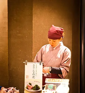 Kyoto Prints: Shop worker in a Japanese food shop wearing the traditional tenuous headscarf