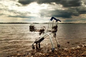 Checkout Prints: shopping trolley abandoned on a beach