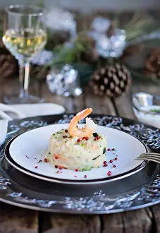 Shrimps Prints: Shrimps and zucchini risotto on wooden table with christmas decorations