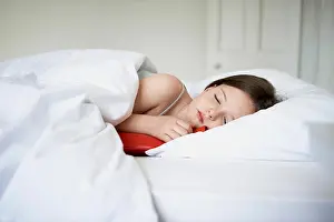 Asleep Prints: Sick little girl sleeping with hot water bottle in bed