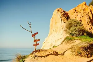 Praia Prints: Sign of possibilities at Falesia beach with orange cliffs in Algarve, Portugal