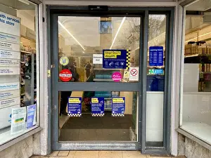 signs in boots the chemist shop window in crouch end haringey N8 north london warn potential thieves against