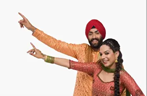 Braids Prints: Sikh couple doing Bhangra the folk dance of Punjab in India