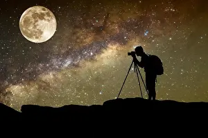 silhouette of man photography take a photo of Milky Way galaxy and full moon on dark night at thailand