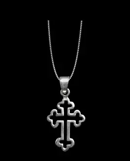 Theology Prints: Silver crucifix necklace cross isolated on black background