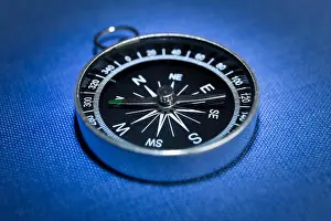 Compass Prints: Simple dry magnetic compass on blue background