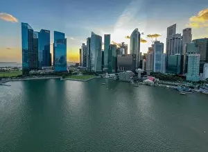 Merlion Prints: SINGAPORE - January 31, 2020: Aerial view of Singapore downtown district in the sunset