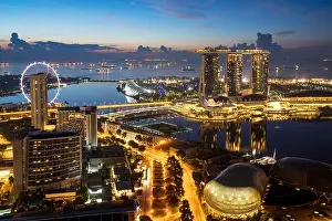 Singapore Marina Bay rooftop view with urban skyscrapers at night in Singapore