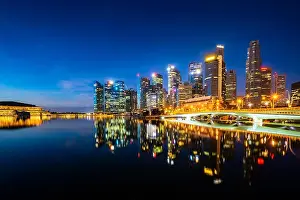 Marina Bay Prints: Singapore skyscraper building in downtown district with water reflection at Marina Bay in night