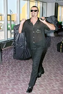 Relaxed Prints: Singer George Michael arriving at London's Heathrow Airport in 1996