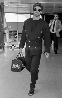 Relaxed Prints: Singer George Michael arriving at London's Heathrow Airport in August 1987