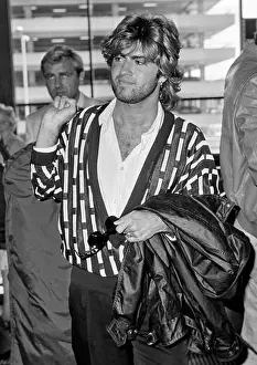 Entertainer Prints: Singer George Michael leaving London's Heathrow Airport in May 1985