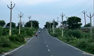 Green Building Prints: single lane highway in india having electric poles on each side
