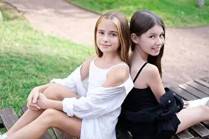 Sibling Prints: sisterhood. two sisters or friends spending time outdoors on sunny summer day