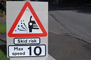 Room For Copy Prints: Skid risk road traffic sign warning with red triangle and black car symbol with max speed 10 mph