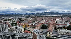 Sky Landscape Prints: The skyline of Alba, Italy, reveals a blend of historic architecture and modern structures under an overcast sky