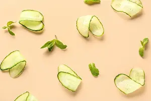Veggie Prints: Slices of cucumber with mint on beige background