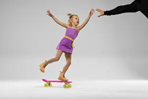 Agility Prints: small blonde girl rides a skateboard