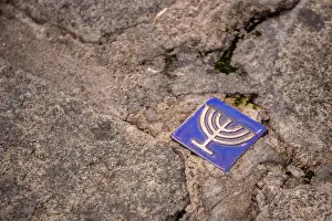 Calle Prints: Small blue tile with menorah symbol embedded in the pavement of the former Jewish quarter